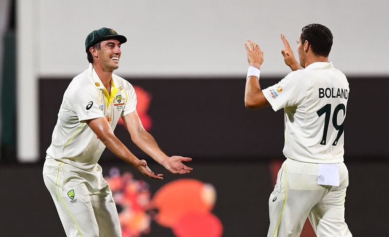 Australia's Scott Boland, right, celebrates with Pat Cummins after dismissing England batsman Sam Billings. AFP