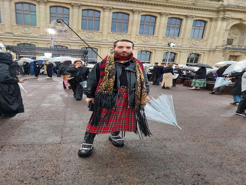 A kilt and an umbrella, in the rain at the Givenchy show.