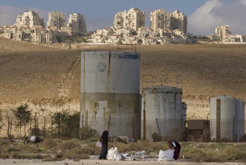 Palestinian women collect scrap timber in the Mishor Adumim industrial zone near the Jewish West Bank settlement of Maaleh Adumim on November 22, 2010. Sebastian Scheiner, File/AP Photo