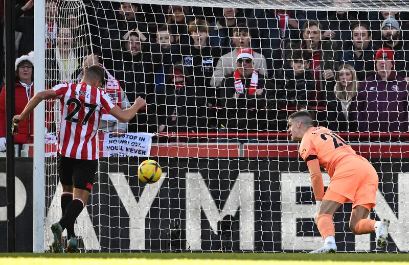 Vitaly Janelt scores Brentford's opening goal past Tottenham goalkeeper Fraser Forster. AFP