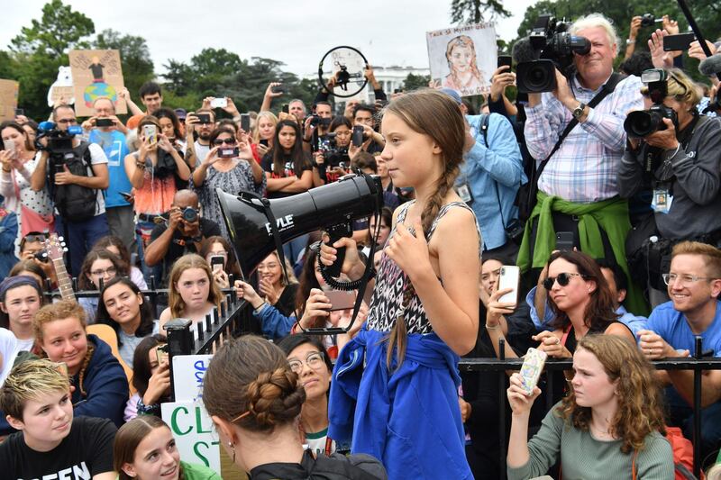 TOPSHOT - Swedish environment activist Greta Thunberg speaks at a climate protest outside the White House in Washington, DC on September 13, 2019. Thunberg, 16, has spurred teenagers and students around the world to strike from school every Friday under the rallying cry "Fridays for future" to call on adults to act now to save the planet. / AFP / Nicholas Kamm
