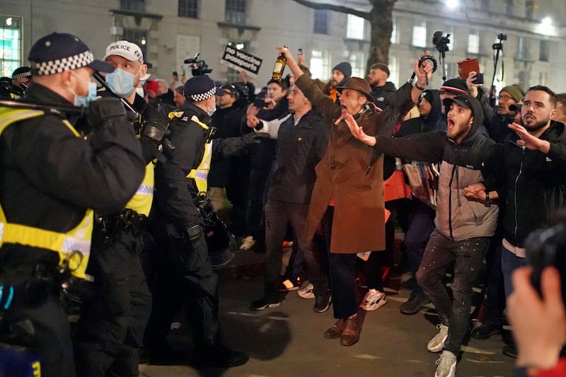 Anti-vaccination protesters scuffle with police during a protest on Whitehall, central London. AP
