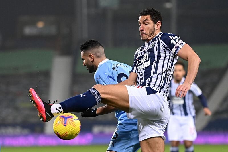 West Bromwich Albion's English midfielder Jake Livermore clears from Manchester City's Algerian midfielder Riyad Mahrez. AFP