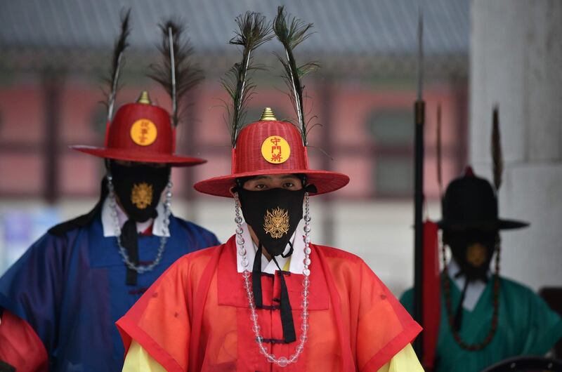 Costumed royal guards perform for tourists at Gyeongbokgung Palace in Seoul, South Korea. AFP