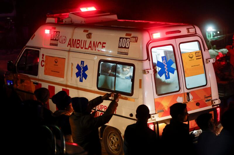 An ambulance carries survivors to hospital as rescuers work to bring out the trapped men. Reuters