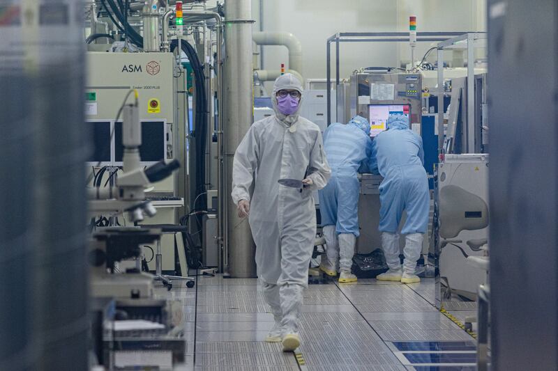 HSINCHU, TAIWAN - SEPTEMBER 16: A student wears cleanroom suit conducts a research inside the clean room of Taiwan Semiconductor Research Institution during a press semiconductor tour at Hsinchu Science Park on September 16, 2022 in Hsinchu, Taiwan. Taiwan's semiconductor manufacturing capabilities are crucial to global supply chains, with megacap companies like Apple, Nvidia and Qualcomm heavily dependent on the island's exports. Taiwan accounts for some 60 percent of global semiconductor foundry revenue, according to media reports.  (Photo by Annabelle Chih/Getty Images)