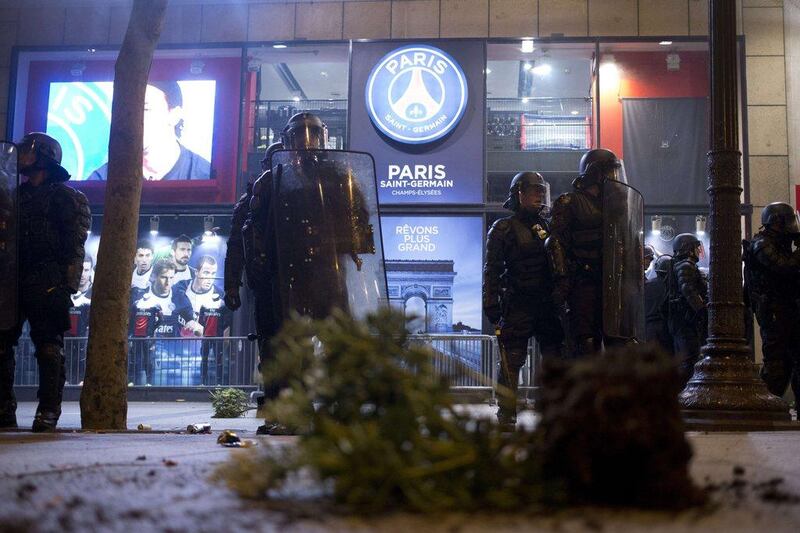 French gendarmes stand guard the PSG shop during title celebrations on Wednesday. Kenzo Tribouillard / AFP / May 7, 2014
