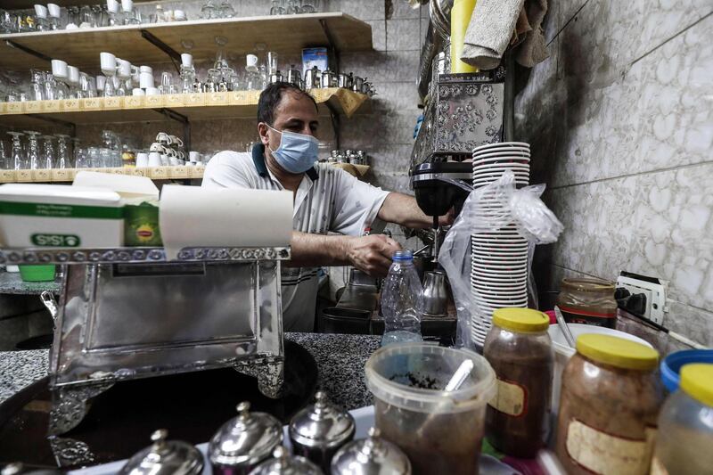 A worker prepares an order at a cafe in the Egyptian capital Cairo after authorities relaxed the lockdown measures in place to curb the spread of coronavirus. AFP