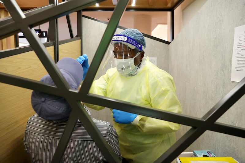 DUBAI, UNITED ARAB EMIRATES , October 14 – 2020 :- Health worker taking the COVID-19 nasal swab test at the COVID 19 testing station set up at Mall of the Emirates in Dubai. (Pawan Singh / The National) For News/Online. Story by Sarwat