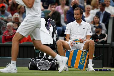 (FILES) In this file photo taken on July 06, 2021 Russia's Daniil Medvedev (R) reacts during a break in play against Poland's Hubert Hurkacz in their men's singles fourth round match on the eighth day of the 2021 Wimbledon Championships at The All England Tennis Club in Wimbledon, southwest London.  - Wimbledon has banned Russian and Belarusian players from the 2022 tournament in response to the invasion of Ukraine, but ATP and WTA organisers branded the move "unfair" and "very disappointing" on April 24, 2022.  The players trageted include Russian men's world number two Daniil Medvedev and Belarusian female world number four Aryna Sabalenka.  And also Russia's Andrey Rublev, who is currently eighth in the ATP rankings, while his compatriot Karen Khachanov is in 26th place.  Russian world number 15 Anastasia Pavlyuchenkova and Victoria Azarenka of Belarus are two of the other top female players who will miss the grass-court Grand Slam.  (Photo by Adrian DENNIS  /  AFP)  /  RESTRICTED TO EDITORIAL USE