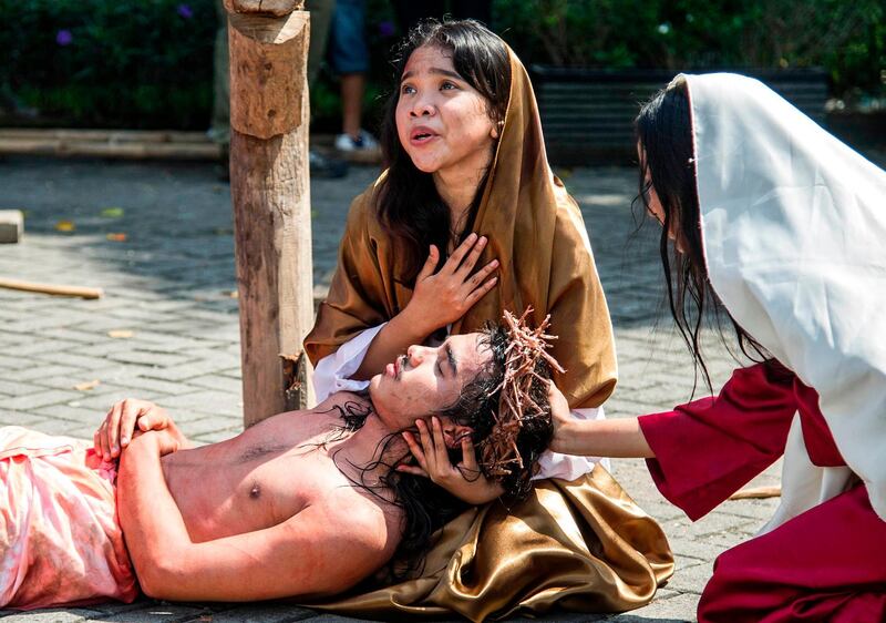 Indonesian Catholics re-enact the crucifixion of Jesus Christ at the compound of St. Mikael church in Surabaya. Juni Kriswanto / AFP Photo