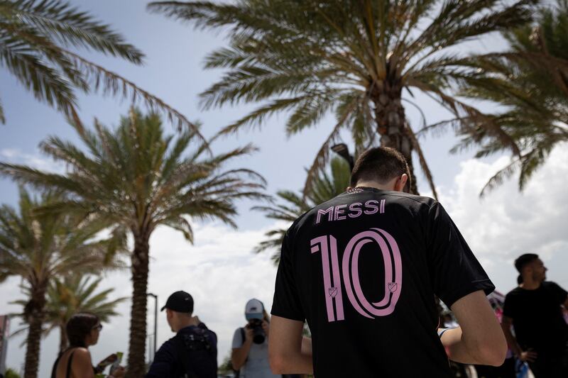 A supporter wears the Inter Miami jersey of Lionel Messi outside the DRV Pnk Stadium. Reuters