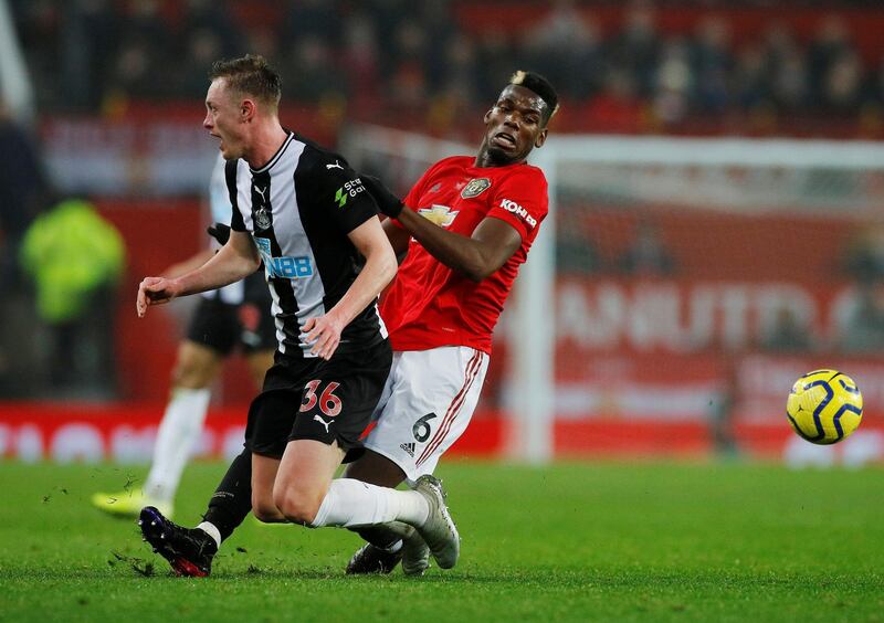 Paul Pogba vies for the ball with Newcastle United's Sean Longstaff. Reuters