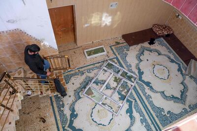 A man inspects damage at a home after a missile was launched by Iran’s IRGC targeting Erbil. AFP