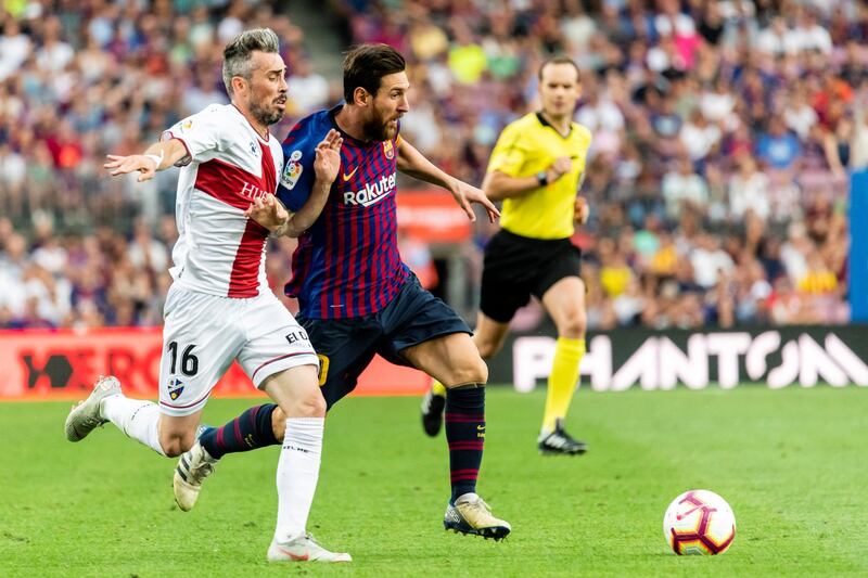 BARCELONA, SPAIN - SEPTEMBER 02: Lionel Andres Messi of FC Barcelona (R) fights for the ball with Luis Carlos Correia Pinto, Luisinho, of SD Huesca (L) during the La Liga 2018-19 match between FC Barcelona and SD Huesca at Camp Nou on 02 September 2018 in Barcelona, Spain. (Photo by Power Sport Images/Getty Images)