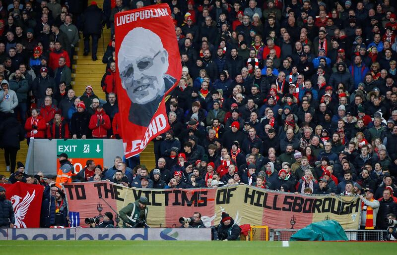 Liverpool fans hold up a sign honouring the 96 victims of the Hillsbrough disaster. Reuters