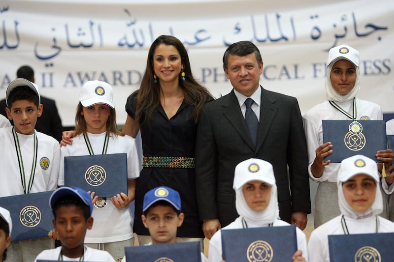 King Abdullah II of Jordan, second from right, and his wife Queen Rania of Jordan, third from left, stand next to  Princess Iman, second from left, during an awards ceremony at the Al Hussein Sport City, in May 2008. Getty Images