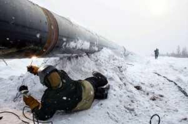 A worker welds a pipeline at the South-Russian OAO Gazprom gas field, 250 km from Urengoy, Eastern Siberia, Russia, on Thursday, Feb. 28, 2008. OAO Gazprom, Russia's largest energy producer, said first quarter profit jumped 30 percent to a record because of higher prices for natural gas, beating estimates. Photographer: Dmitry Beliakov/Bloomberg News