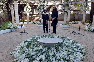 epa09003572 German Monika Borgmann (R), wife of assassinated activist and Hezbollah critic Lokman Slim prays with his sister Rasha (L) during a memorial service to pay tribute to him, in Dahyieh Beirut, Lebanon, 11 February 2021. Slim found on 04 February 2021 shot to death in a rental car that was found in Nabatiyeh, southern Lebanon. The motive behind the assassination was not clear.  EPA/WAEL HAMZEH