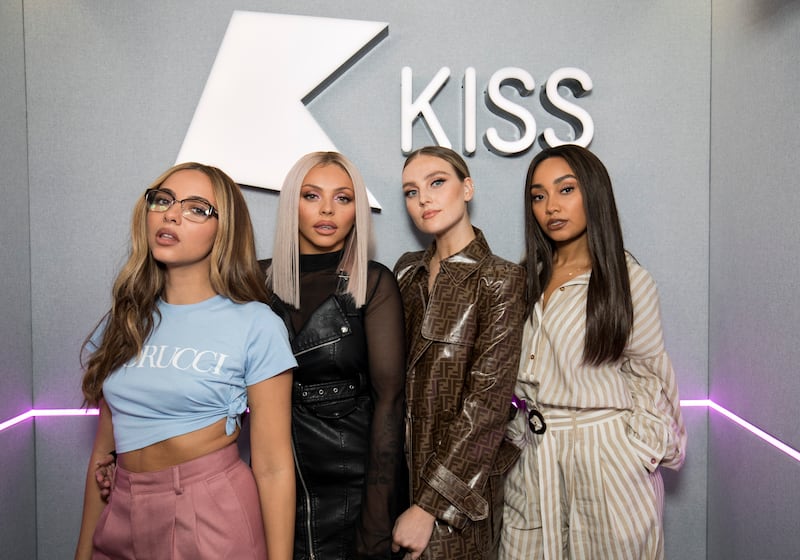 Jesy Nelson, in a leather dress with sheer sleeves, with her Little Mix bandmates, visits Kiss FM studio on October 11, 2018 in London