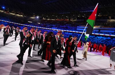Flag-bearers Zeyad Eashash Julyana Al Sadeq of Jordan lead their contingent during the athletes parade at the opening ceremony in Tokyo. Reuters