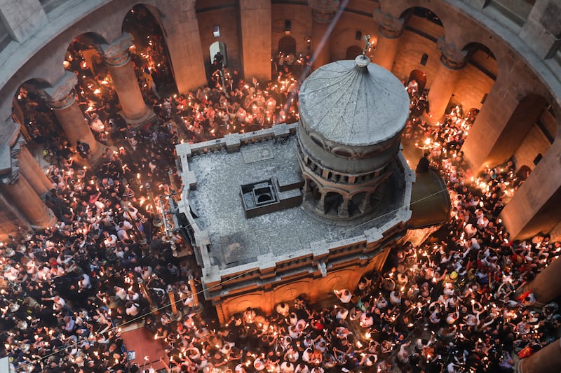 Christian worshippers gather at the Tomb of Christ as they wait for the miracle of the Holy Fire ceremony to occur, in the Church of the Holy Sepulchre, in Jerusalem, Israel.  EPA 