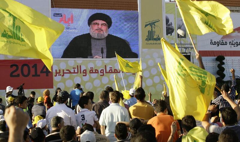 Supporters of Hizbollah listen to their leader, Hassan Nasrallah, as he speaks via a giant screen during the celebration in the southern town of Bint Jbeil, Lebanon. EPA