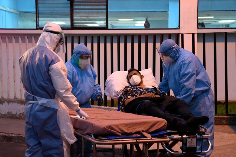 Municipal firefighters transfer a patient with symptoms related to coronavirus, at the Covid-19 unit of San Juan de Dios hospital in Guatemala City. AFP