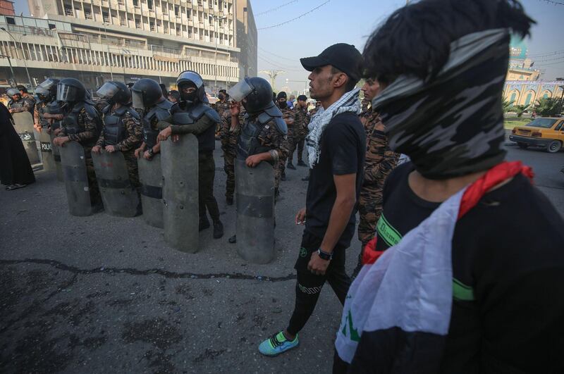 Iraqi riot policemen block access to central Baghdad's Sinak bridge which links the capital's Green Zone with the rest of the city, as protesters gather in Tahrir Square.  AFP
