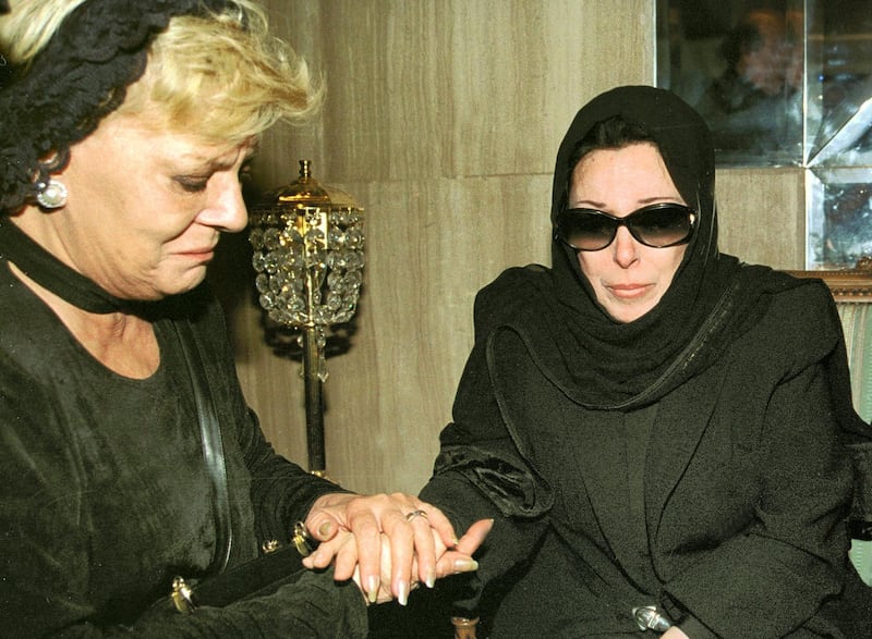 Egyptian actress Nadia Lutfi (L) comforts late film star Soad Hosni's sister, singer Najat as-Saghira, late 27 June 2001 at Cairo airport upon the arrival of Hosni's body from London for burial in Egypt. Thousands of Egyptians, many sobbing openly, took part in the funeral of the "Cinderella" of the Arab screen, who died a week ago after falling from the sixth floor of a building in London 21 June. (Film) AFP PHOTO/Amr Mahmoud (Photo by AMR MAHMOUD / AFP)