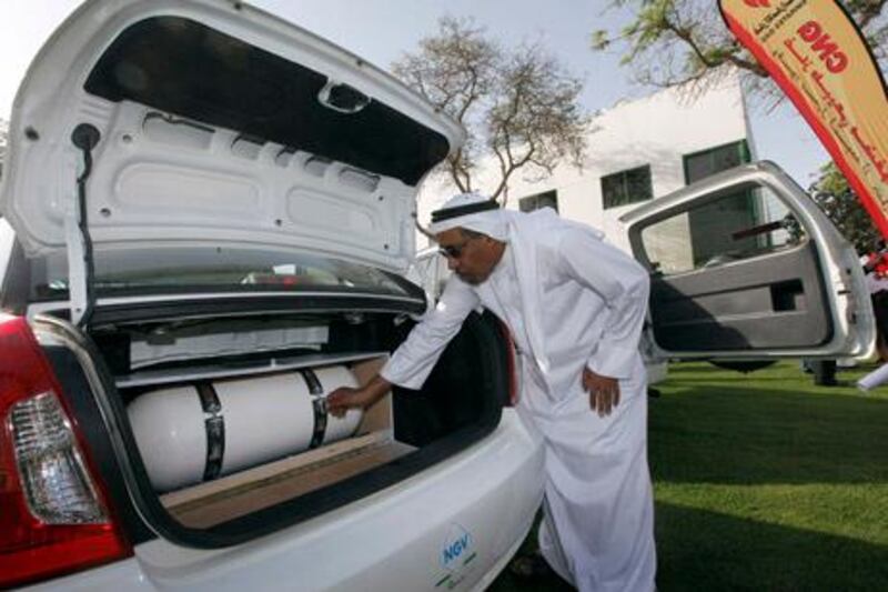 Dubai , United Arab Emirates- February, 22 , 2011:    Humaid Al Marri, Director of Transportation, Dubai Municipality takes a closer look at the  Natural Gas installed in the car  duirng the launch of the first phase project to convert the vehicles to natural gas  in Dubai.   ( Satish Kumar / The National )