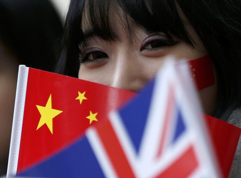 A supporter of China's President Xi Jinping waits on the Mall for him to pass during his ceremonial welcome, in London (REUTERS/Peter Nicholls)