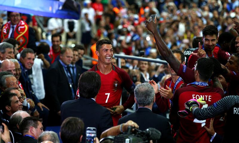 PARIS, FRANCE - JULY 10:  Cristiano Ronaldo of Portugal celebrates during the award ceremony after his team's 1-0 win in the UEFA EURO 2016 Final match between Portugal and France at Stade de France on July 10, 2016 in Paris, France.  (Photo by Alex Livesey/Getty Images)