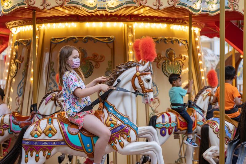 Children enjoy the carousel in the Mobility district. Photo: Expo 2020 Dubai