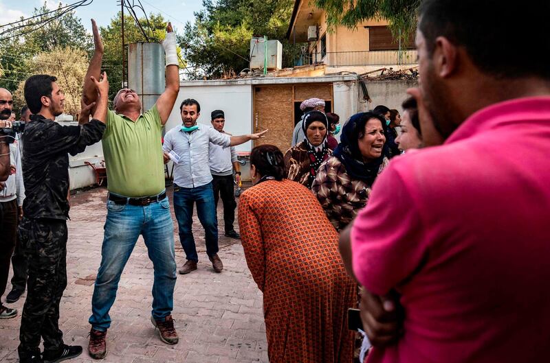 People react as the body of a man killed during Turkish shelling in the area surrounding the Syrian Kurdish town of Ras Al Ain arrives at a hospital in the nearby town of Tal Tamr following the announced ceasefire. AFP