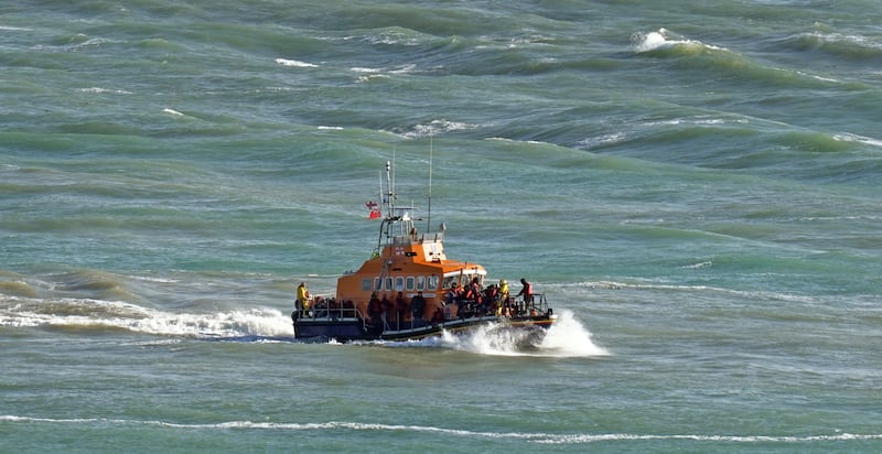 A group of people thought to be migrants are taken to Dover, Kent, onboard the Ramsgate Lifeboat following an incident in the English Channel on October 27, 2022. PA