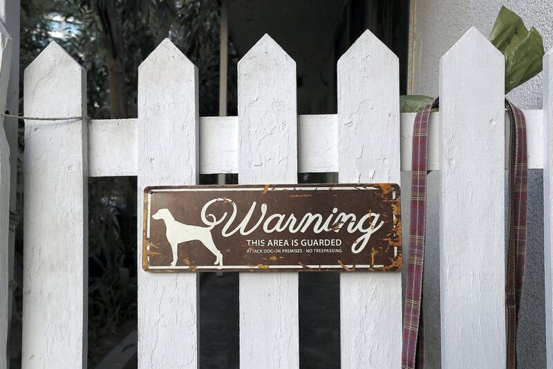 DUBAI , UNITED ARAB EMIRATES , August 2 – 2018 :- Dog warning sign on the entrance gate of one of the villa at the Desert Springs Village in Tecom area in Dubai. ( Pawan Singh / The National )  For News. Story by Patrick Ryan