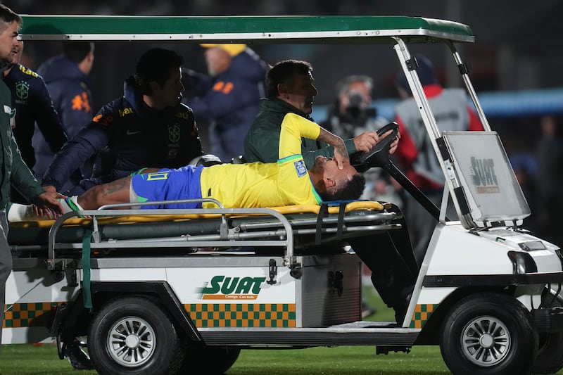 Neymar is carried off the pitch on a stretcher. AP
