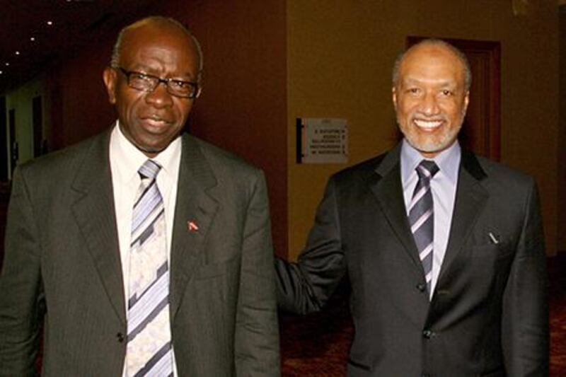 Jack Warner, left, who resigned from Fifa in 2012 following an investigation that found him to have committed fraud, is alleged to have received Dh4.4m from a company owned by Mohamed Bin Hammam, right, according to The Telegraph. Shirley Bahadur / AP Photo