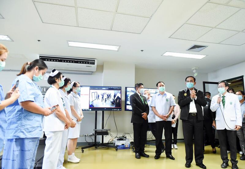 Thai Prime Minister Prayut Chan-o-cha, second right, talking to nurses and medics during a visit to the Erawan 2 field hospital in Bangkok, Thailand,  on April 21, 2021. EPA / Royal Thai Government handout