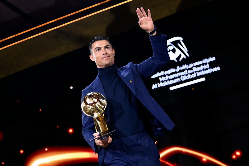 Cristiano Ronaldo holds a career award at the Globe Soccer Awards ceremony in Dubai, Friday, Jan.  19, 2024. AP