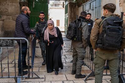 A Muslim woman walks by armed police in the the Old City of Jerusalem. Getty Images