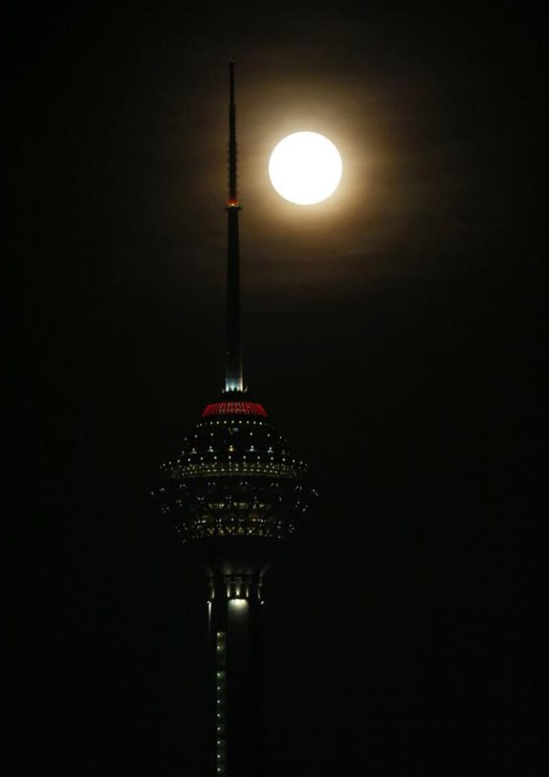 The supermoon rises behind the Milad telecommunications tower in the Iranian capital Tehran. Atta Kenare / AFP