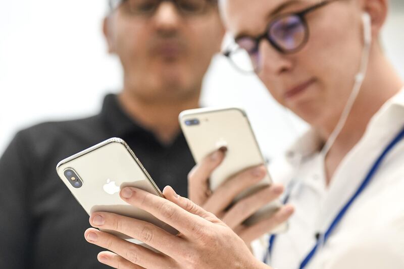 An attendee takes a photograph of an Apple Inc. iPhone X during an event at the Steve Jobs Theater in Cupertino, California, U.S., on Tuesday, Sept. 12, 2017. Apple Inc. unveiled its most important new iPhone for years to take on growing competition from Samsung Electronics Co., Google and a host of Chinese smartphone makers. The device, coming a decade after the original model, is Apple's first major redesign since 2014 and represents a significant upgrade to the iPhone 7 line. Photographer: David Paul Morris/Bloomberg