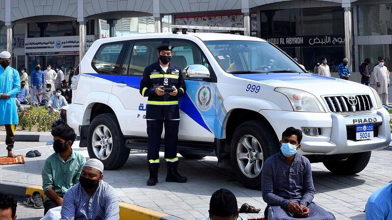 Police officers in Sharjah raise awareness and remind people of the Covid-19 safety rules.
