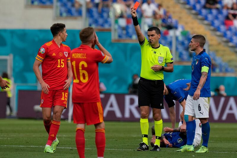 Referee Ovidiu Hategan shows a red card to Wales' Ethan Ampadu. AP
