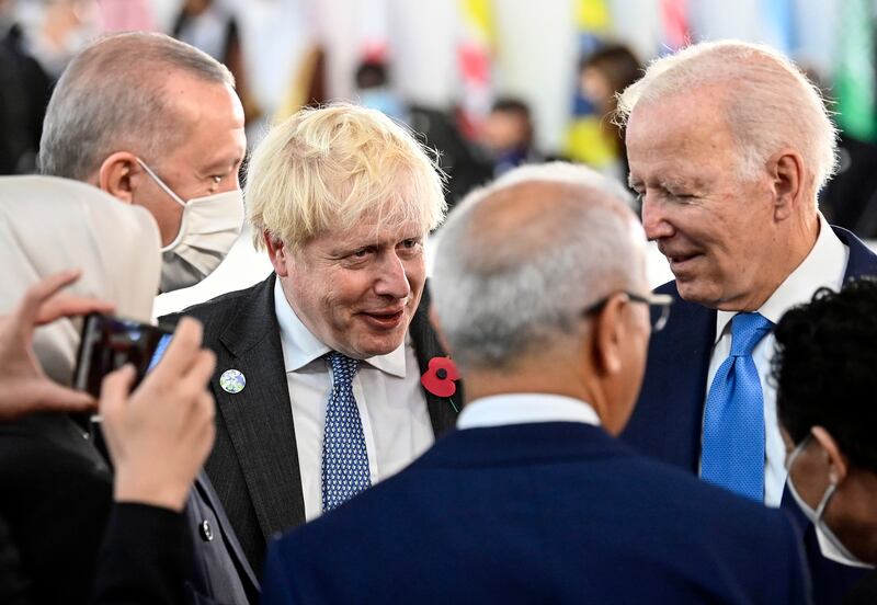 UK Prime Minister Boris Johnson, centre, and US President Joe Biden, right, during the plenary session of the G20 summit in Rome. EPA