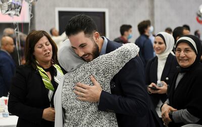 Abdullah Hammoud hugs his relative, Taghrid Beydoun, in Dearborn, Michigan. Detroit News via AP