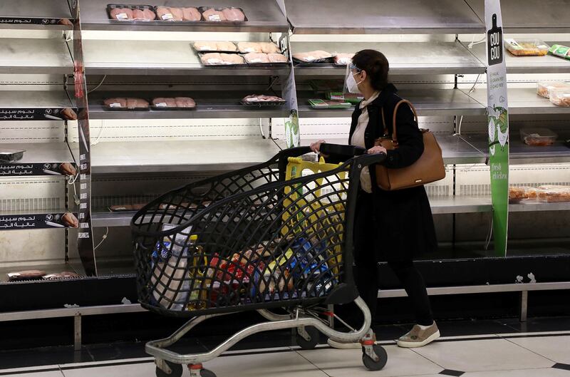 A shopper walks past near-empty shelves at a supermarket in Beirut, Lebanon March 16, 2021. Picture taken March 16, 2021. REUTERS/Mohamed Azakir