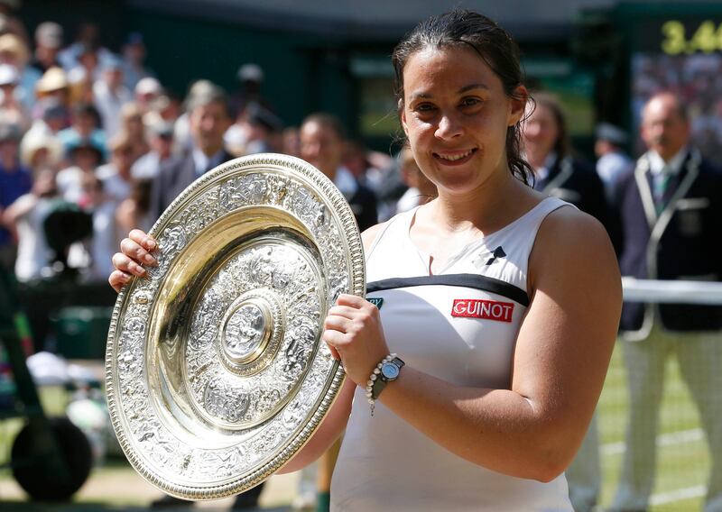 Marion Bartoli of France holds her winners trophy, the Venus Rosewater Dish, after defeating Sabine Lisicki of Germany in their women's singles final tennis match at the Wimbledon Tennis Championships, in London July 6, 2013.       REUTERS/Suzanne Plunkett (BRITAIN  - Tags: SPORT TENNIS)